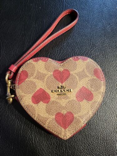 coach bag with pink hearts.